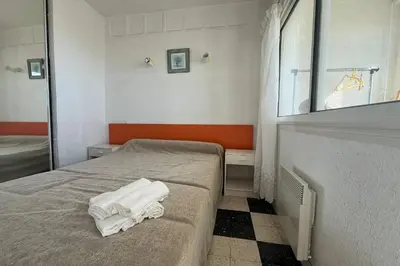 a bedroom with a bed with two towels on it at Spacious apartment on the seafront in Port-la-Nouvelle