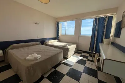 a hotel room with a bed and a window at Spacious 60 m nest with sea view in Port-la-Nouvelle