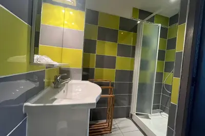 a bathroom with a sink and a shower at Spacious 60 m nest with sea view in Port-la-Nouvelle