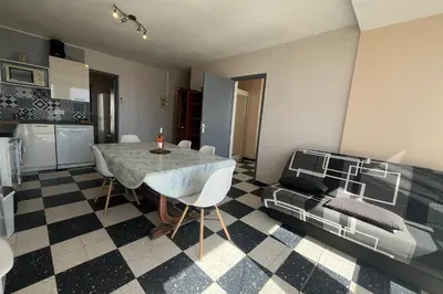 a kitchen and dining room with a table and a couch at Spacious 60 m nest with sea view in Port-la-Nouvelle