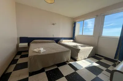 a small bedroom with a bed and a window at Spacious 60 m nest with sea view in Port-la-Nouvelle