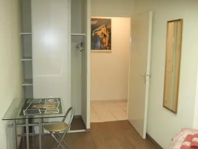 a room with a glass table and a chair at Appartement CarcaLuxe in Carcassonne