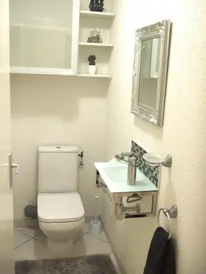 a bathroom with a toilet and a sink at Appartement CarcaLuxe in Carcassonne