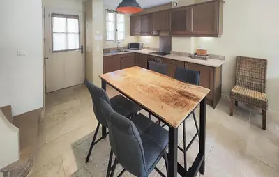 a kitchen with a wooden table and chairs at Gorgeous Home In Saint-Laurent-De-La-Ca With Wifi in Saint-Laurent-de-la-Cabrerisse