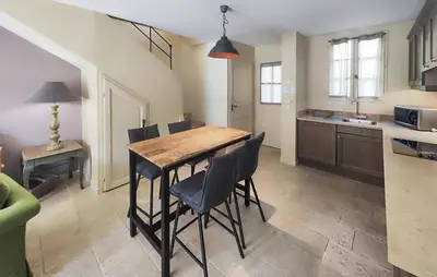 a kitchen with a wooden table and chairs at Gorgeous Home In Saint-Laurent-De-La-Ca With Wifi in Saint-Laurent-de-la-Cabrerisse