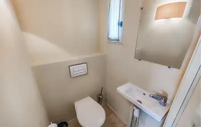 a small bathroom with a toilet and a sink at Gorgeous Home In Saint-Laurent-De-La-Ca With Wifi in Saint-Laurent-de-la-Cabrerisse