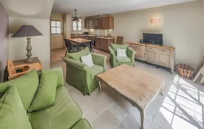 a living room with a couch and chairs and a table at Gorgeous Home In Saint-Laurent-De-La-Ca With Wifi in Saint-Laurent-de-la-Cabrerisse