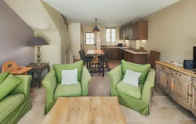 a living room with two green chairs and a table at Gorgeous Home In Saint-Laurent-De-La-Ca With Wifi in Saint-Laurent-de-la-Cabrerisse