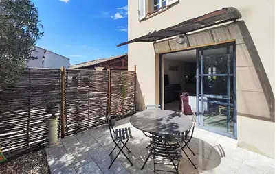 a patio with a table and chairs and a fence at Lovely Home In Saint-Laurent-De-La-Ca in Saint-Laurent-de-la-Cabrerisse