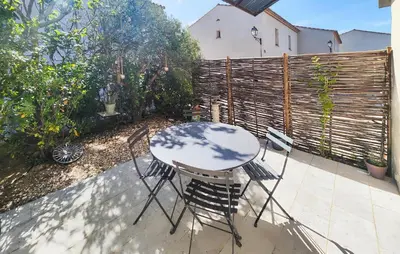 a table and chairs sitting on a patio at Lovely Home In Saint-Laurent-De-La-Ca in Saint-Laurent-de-la-Cabrerisse