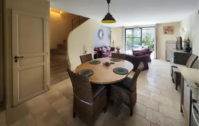 a kitchen and dining room with a table and chairs at Lovely Home In Saint-Laurent-De-La-Ca in Saint-Laurent-de-la-Cabrerisse
