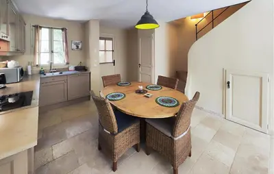 a kitchen with a wooden table and some chairs at Lovely Home In Saint-Laurent-De-La-Ca in Saint-Laurent-de-la-Cabrerisse