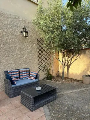 a patio with a couch and a coffee table at Studio 2 personnes in Vinassan