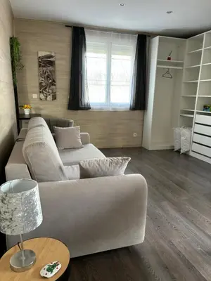 a living room with a couch and a table at Studio 2 personnes in Vinassan