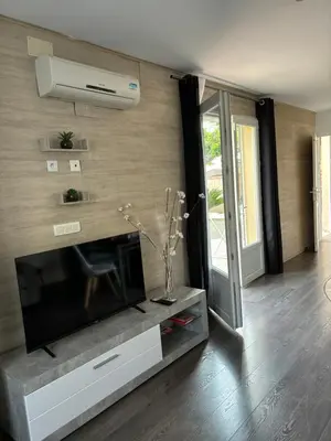 a living room with a flat screen tv on a wall at Studio 2 personnes in Vinassan