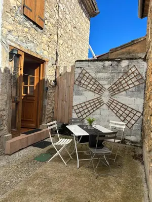a table and chairs in front of a building at Petit Grange Puivert no 26 in Puivert