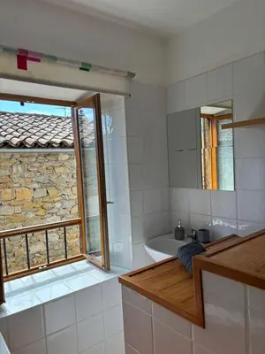 a bathroom with a tub and a sink and a mirror at Petit Grange Puivert no 26 in Puivert