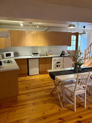 a kitchen with a table and a stove and a table and chairs at Petit Grange Puivert no 26 in Puivert