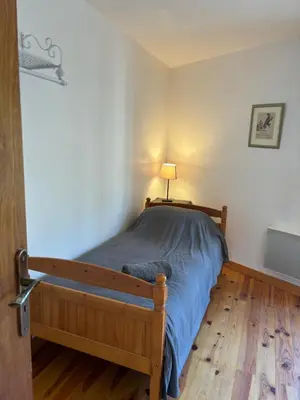 a bedroom with a bed with a blue comforter at Petit Grange Puivert no 26 in Puivert