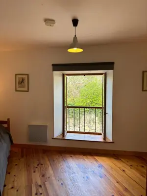an empty room with a window and wooden floors at Petit Grange Puivert no 26 in Puivert