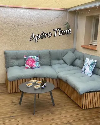 a living room with a couch and a table at Alba zen & spa in Villefranche-de-Lauragais