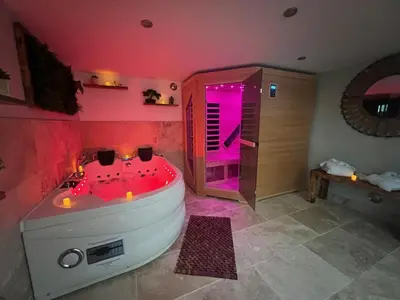 a large bathroom with a tub with pink lighting at Alba zen & spa in Villefranche-de-Lauragais