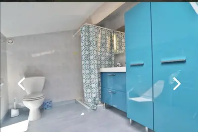 a bathroom with a blue cabinet and a toilet at Le Gîte des étoiles de la Clape in Salles-d'Aude