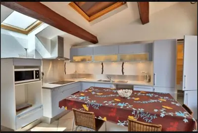 a kitchen with a table and chairs in a kitchen at Le Gîte des étoiles de la Clape in Salles-d'Aude