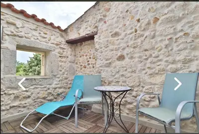 two chairs and a table on a patio at Le Gîte des étoiles de la Clape in Salles-d'Aude
