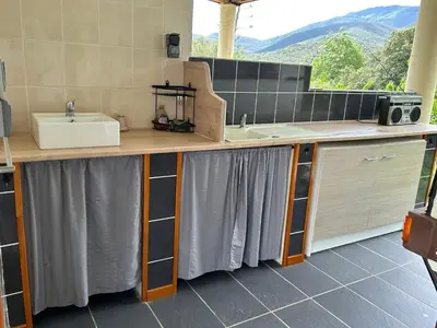a bathroom with a sink and a counter top at Au chant des cigales in Mons