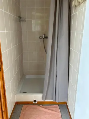 a bathroom with a shower with a shower curtain at Au chant des cigales in Mons