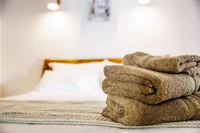 a pile of towels sitting on top of a bed at La Loubière - Gîte in Cessenon
