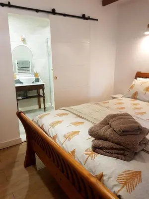 a bedroom with a bed with towels on it at La Loubière - Gîte in Cessenon