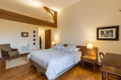 a bedroom with a bed and a desk and a chair at Grande Maison de Charme a 5 mn du centre ville in Narbonne