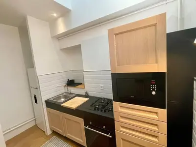 a kitchen with a stove and a microwave at Dame Carcas in Carcassonne