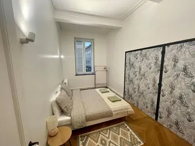 a small room with a bed and a window at Dame Carcas in Carcassonne