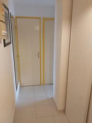 an empty hallway with two doors in a room at Vagues et Vignes Gruissan Appt T2 bien placé tout équipé WIFI avec parking privé in Gruissan