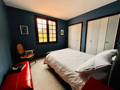 a bedroom with blue walls and a bed and a window at Apartment with views in Limoux