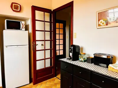 a kitchen with a refrigerator and a microwave at Apartment with views in Limoux