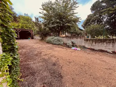 a yard with a dirt road and a garage at Apartment with views in Limoux