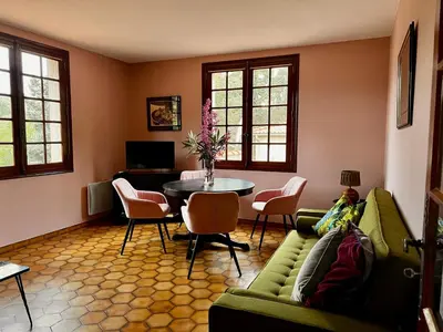 a living room with a green couch and a table at Apartment with views in Limoux