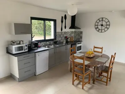 a kitchen with a table and a dining room at Les pontils in Limoux