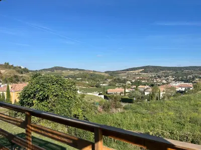 a view of a town from a wooden balcony at Les pontils in Limoux