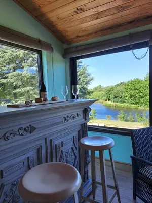 a bedroom with a blue bed and a window at Maison vue sur lac en moyenne montagne in Pradelles-Cabardès
