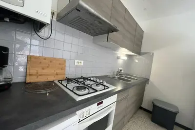 a kitchen with a stove and a sink at Spacious nest with sea view in Port-la-Nouvelle