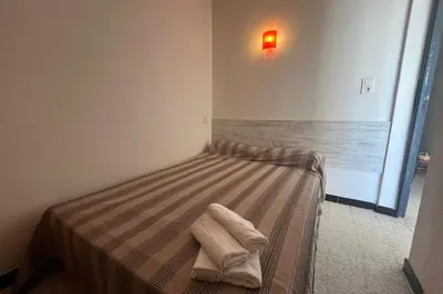 a bedroom with a bed with towels on it at Spacious nest with sea view in Port-la-Nouvelle