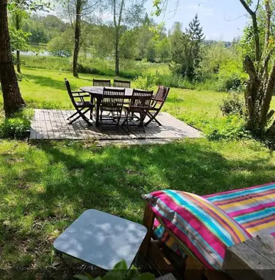 a picnic table and chairs in the grass at Chaleureux Chalet Lac Roussinas in Anglès