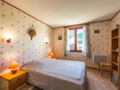 a bedroom with a bed and a window at Holiday Home La maison du carignan by Interhome in Armissan