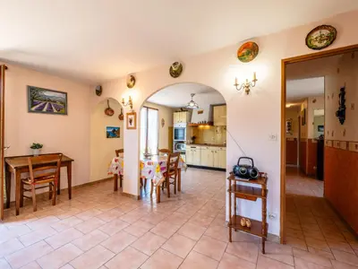 a kitchen and dining room with a table and chairs at Holiday Home La maison du carignan by Interhome in Armissan