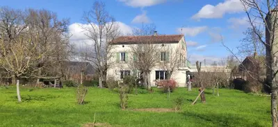 an old white house in a field with trees at Chambre d'hôte chez l'habitant à la campagne in Cambounet-sur-le-Sor